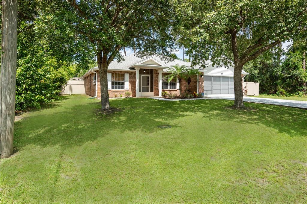 29 Rybark Lane Palm Coast, FL 32164 - Photo 37 of 41 a front view of a house with yard and green space