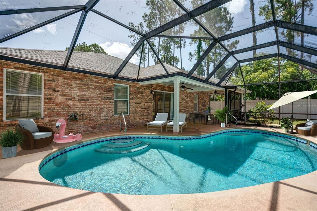 29 Rybark Lane Palm Coast, FL 32164 - Photo 41 of 41 a view of a house with backyard sitting area and swimming pool