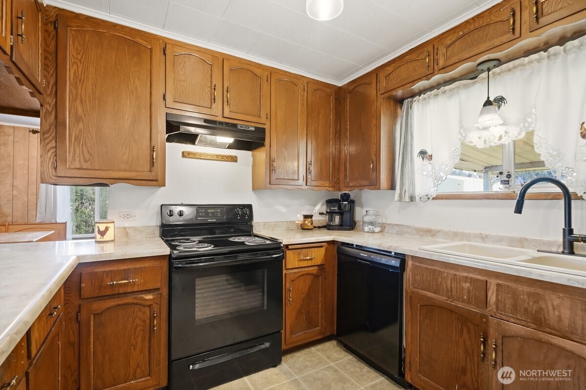 325 3rd Street Morton, WA 98356 - Photo 11 of 40 a kitchen with stainless steel appliances granite countertop a sink stove and refrigerator