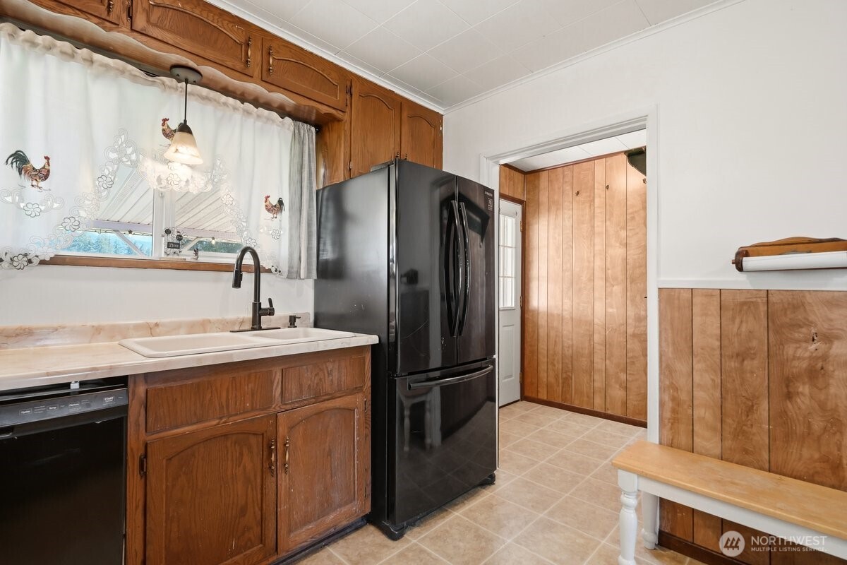325 3rd Street Morton, WA 98356 - Photo 12 of 40 a kitchen with stainless steel appliances granite countertop a refrigerator and a sink