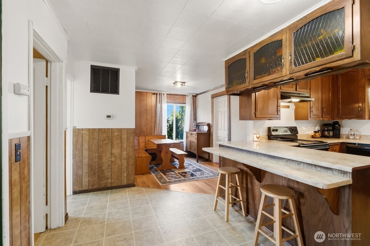 325 3rd Street Morton, WA 98356 - Photo 14 of 40 a kitchen with stainless steel appliances granite countertop a refrigerator and a stove top oven
