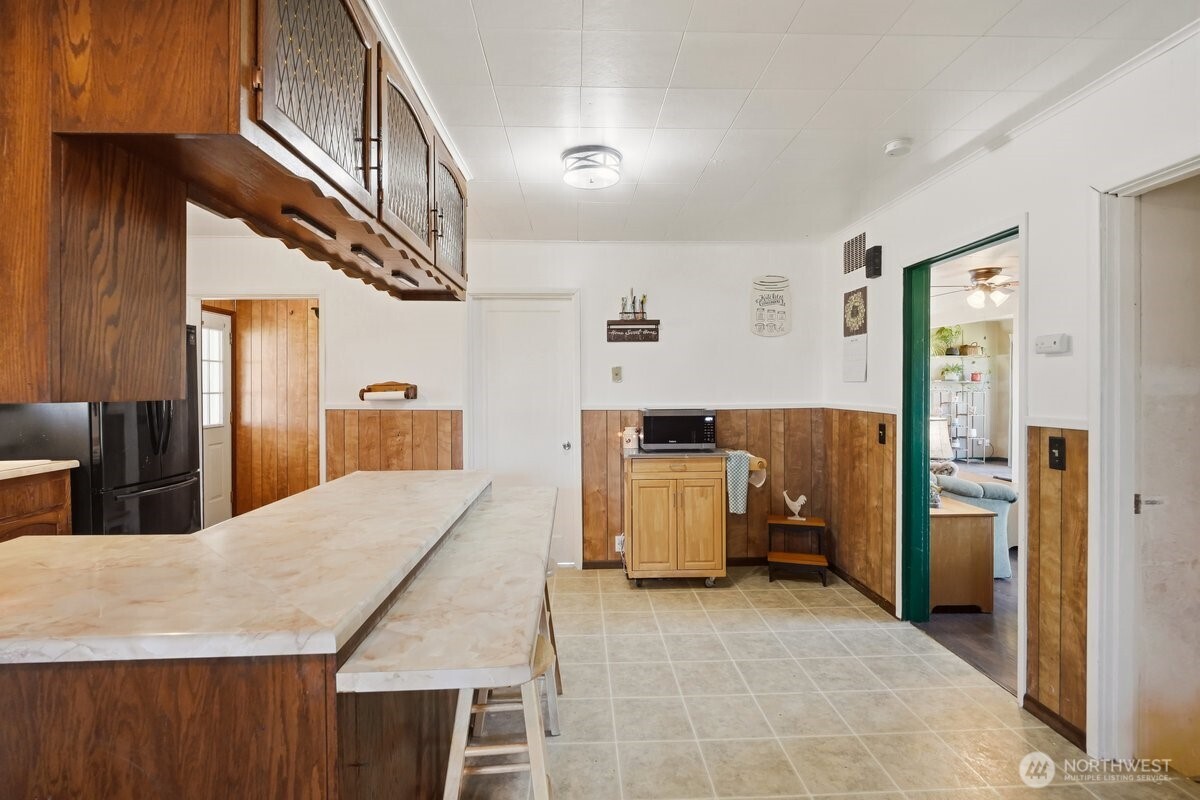 325 3rd Street Morton, WA 98356 - Photo 15 of 40 a kitchen with stainless steel appliances kitchen island a refrigerator and a stove