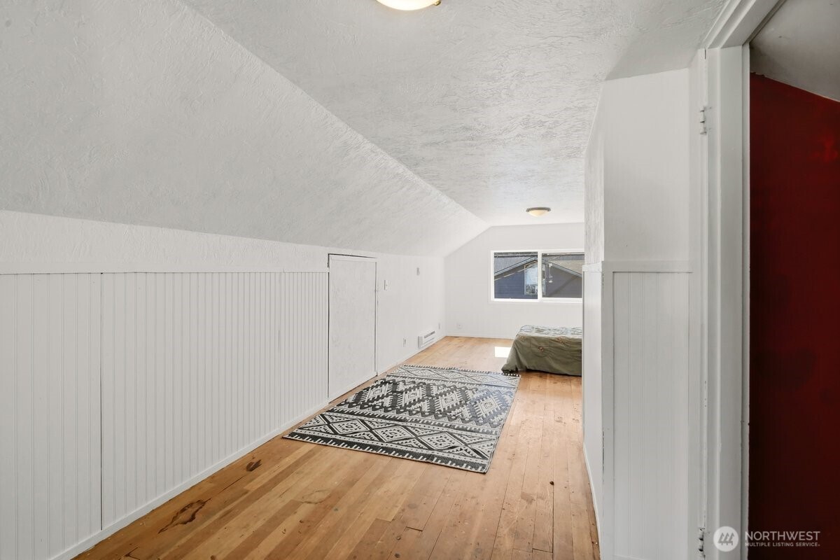 325 3rd Street Morton, WA 98356 - Photo 26 of 40 a bedroom with a bed and wooden floor