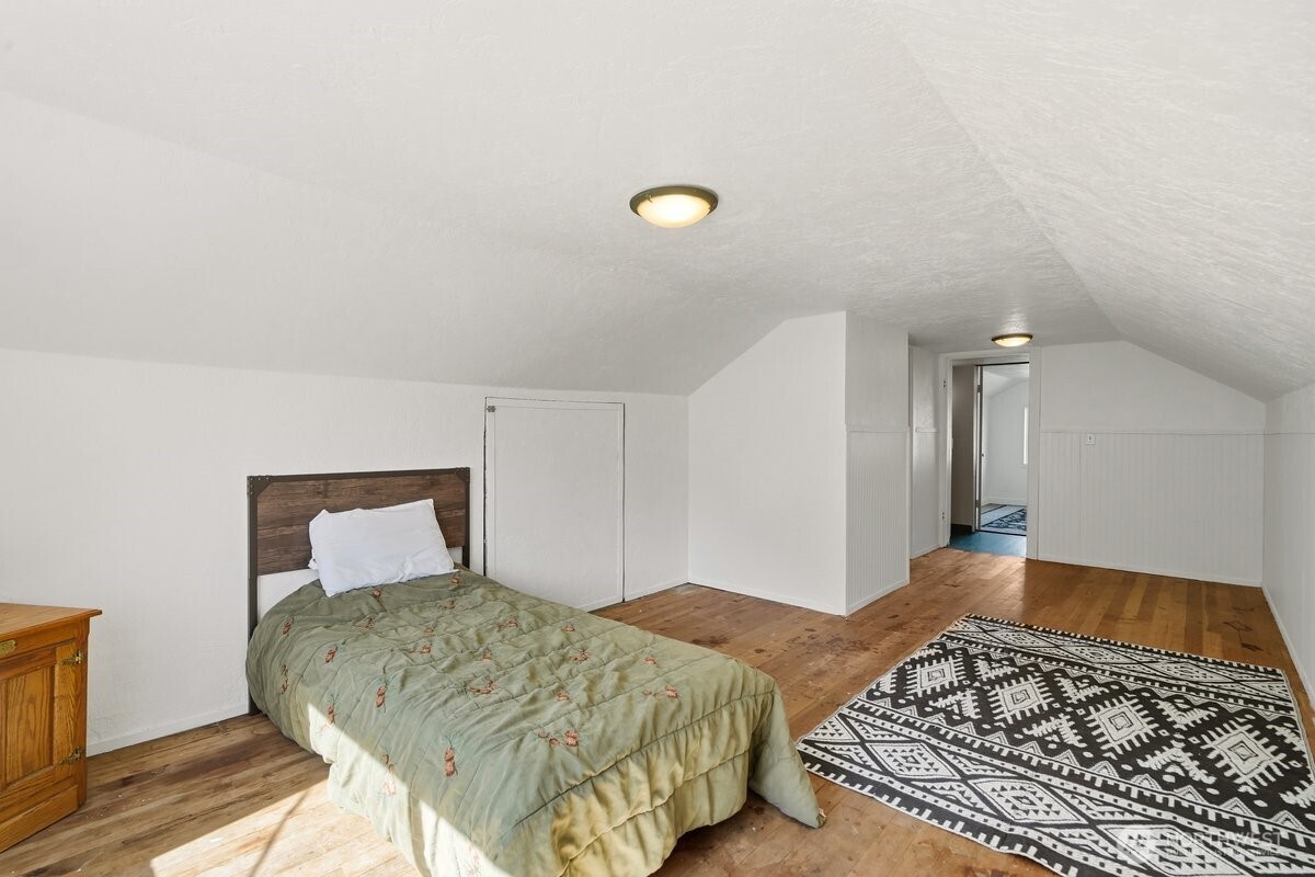 325 3rd Street Morton, WA 98356 - Photo 28 of 40 a bedroom with a bed and wooden floor
