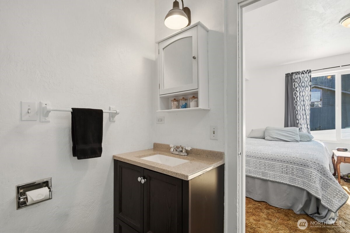 325 3rd Street Morton, WA 98356 - Photo 8 of 40 a bathroom with a sink vanity and mirror