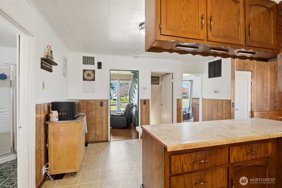 325 3rd Street Morton, WA 98356 - Photo 10 of 40 a kitchen with stainless steel appliances kitchen island granite countertop a refrigerator and microwave