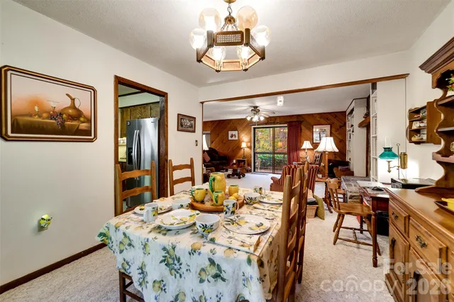 a view of a dining room with furniture and chandelier