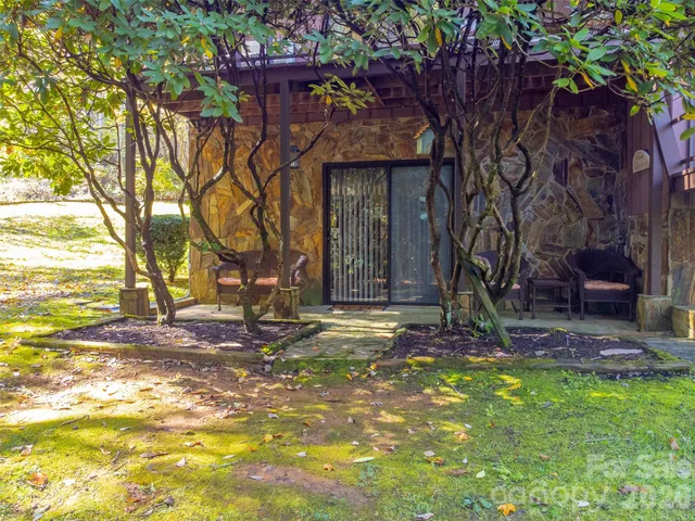 a backyard of a house with table and chairs