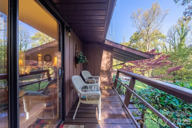 a view of balcony with wooden floor and outdoor seating