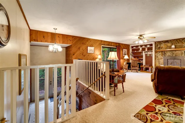 a living room with lots of furniture and a large window
