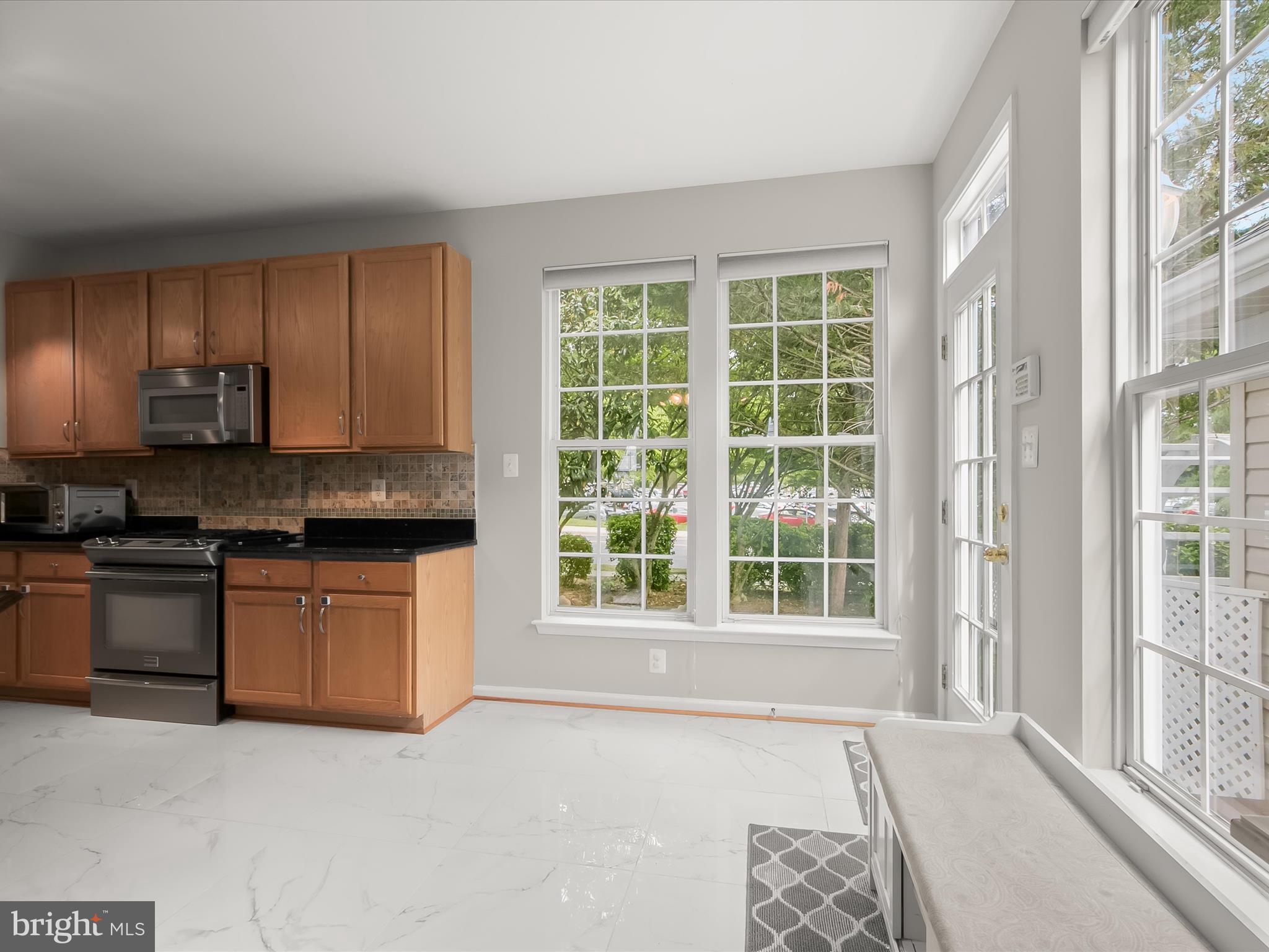 9808 Darcy Forest Drive Silver Spring, MD 20910 - Photo 21 of 82 a kitchen with stainless steel appliances granite countertop a stove a sink and a refrigerator