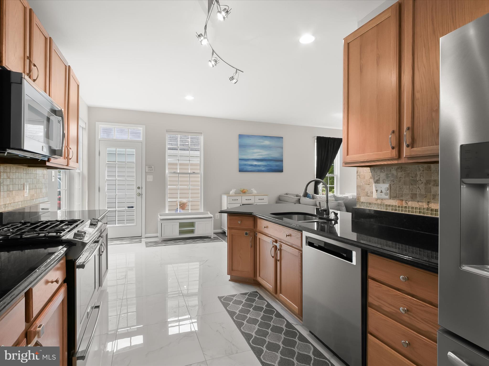9808 Darcy Forest Drive Silver Spring, MD 20910 - Photo 25 of 82 a kitchen with stainless steel appliances a sink stove and refrigerator