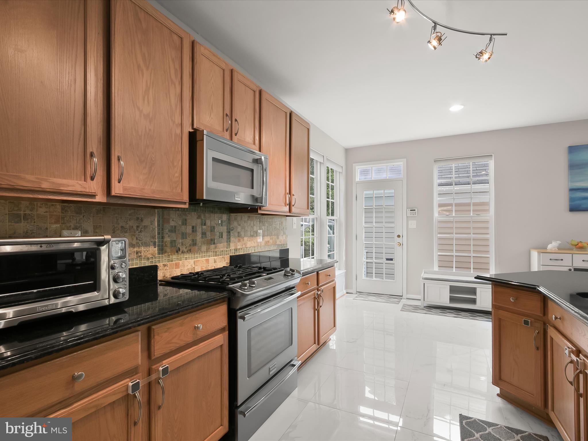 9808 Darcy Forest Drive Silver Spring, MD 20910 - Photo 26 of 82 a kitchen with stainless steel appliances granite countertop a stove a sink and a microwave