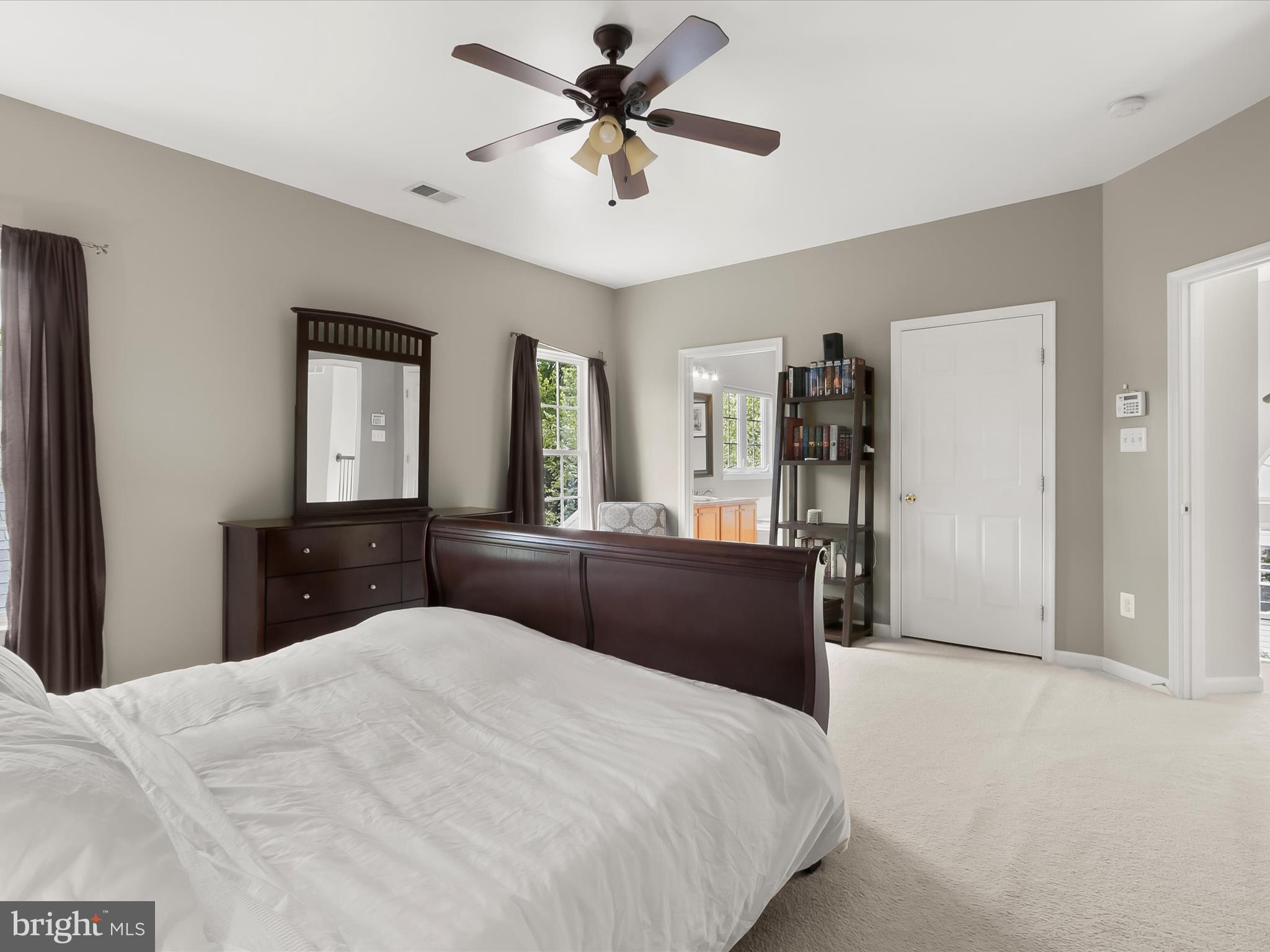 9808 Darcy Forest Drive Silver Spring, MD 20910 - Photo 31 of 82 a bedroom with a bed and a chandelier
