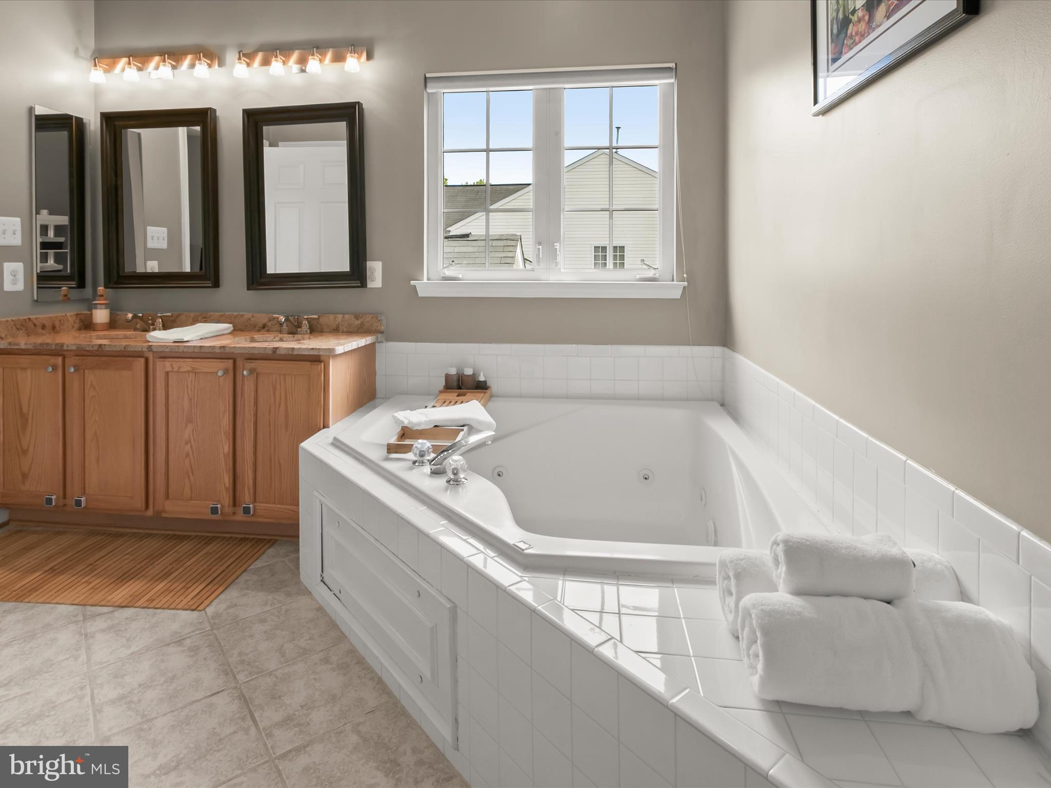 9808 Darcy Forest Drive Silver Spring, MD 20910 - Photo 35 of 82 a bathroom with a tub sink and mirror