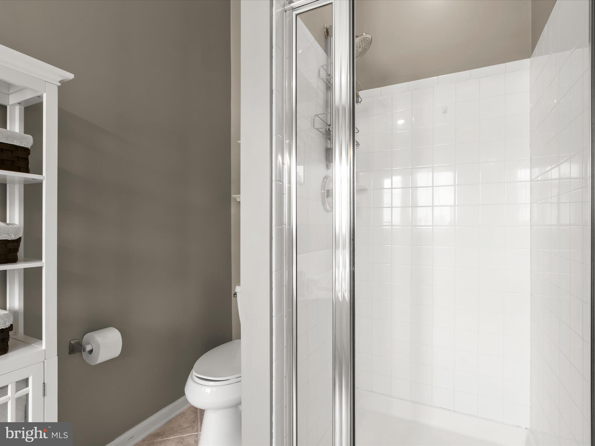 9808 Darcy Forest Drive Silver Spring, MD 20910 - Photo 37 of 82 a bathroom with a granite countertop toilet a sink and a mirror