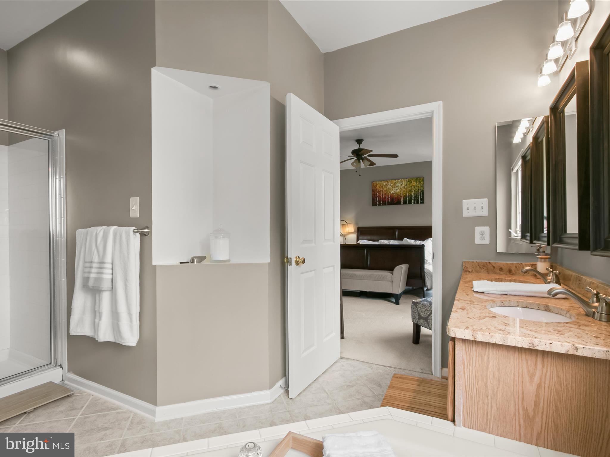 9808 Darcy Forest Drive Silver Spring, MD 20910 - Photo 38 of 82 a en suite bathroom with a granite countertop sink and a mirror
