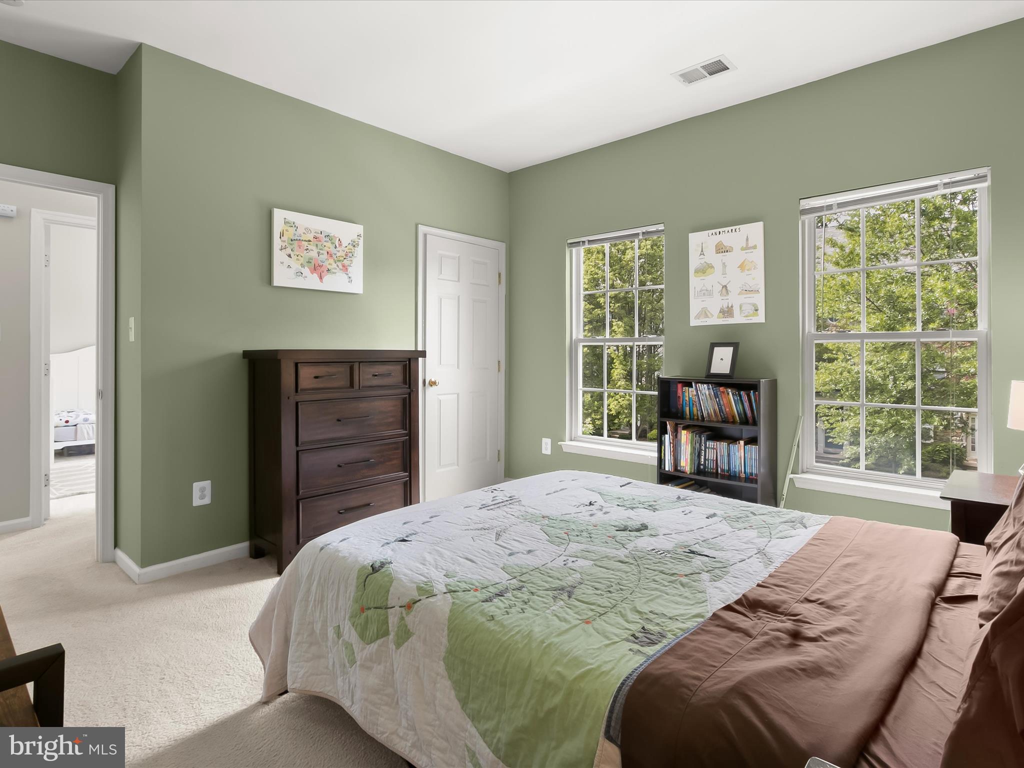 9808 Darcy Forest Drive Silver Spring, MD 20910 - Photo 45 of 82 a spacious bedroom with a bed and a dresser next to a window