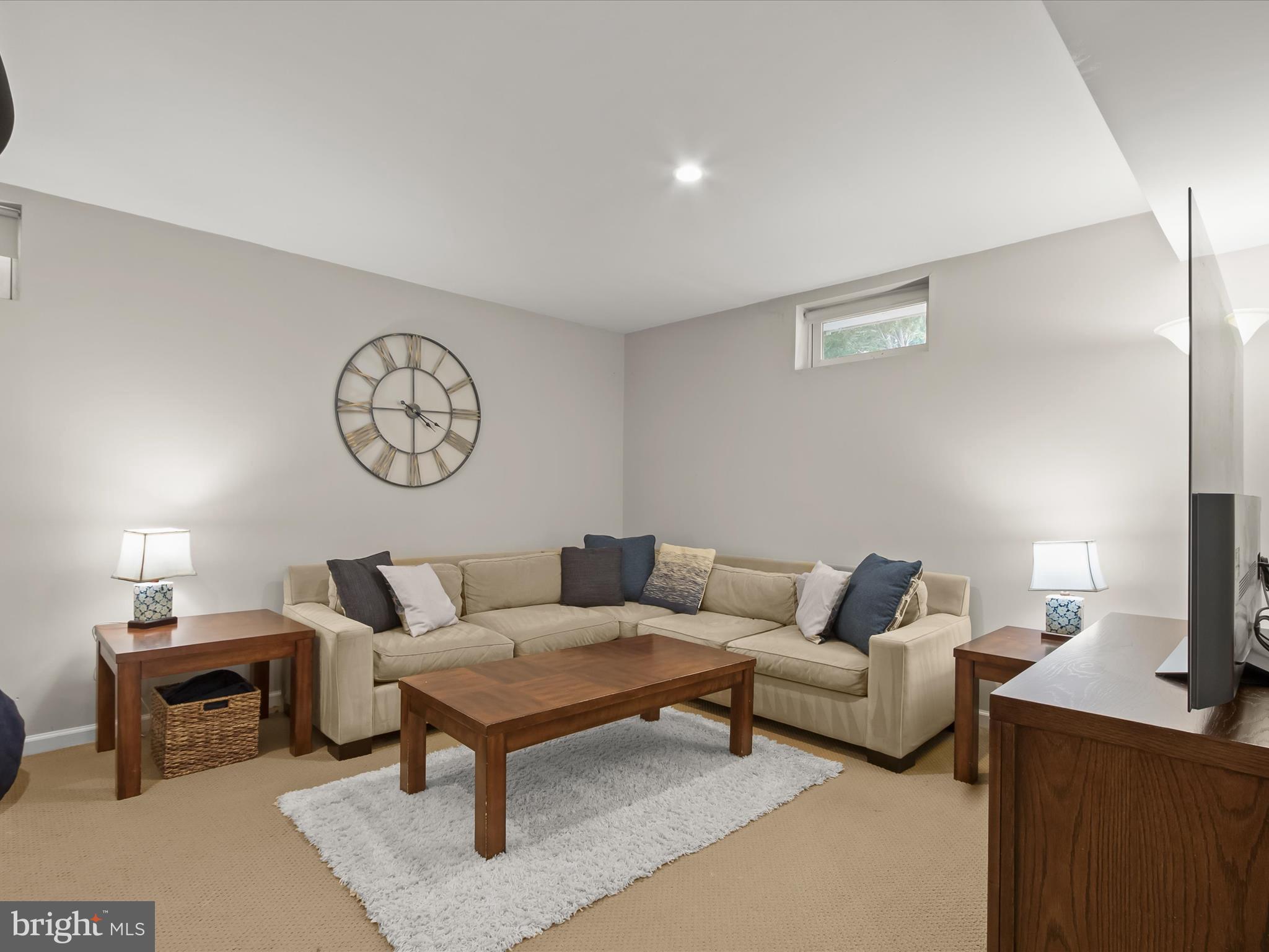 9808 Darcy Forest Drive Silver Spring, MD 20910 - Photo 49 of 82 a living room with furniture a clock on wall and a lamp