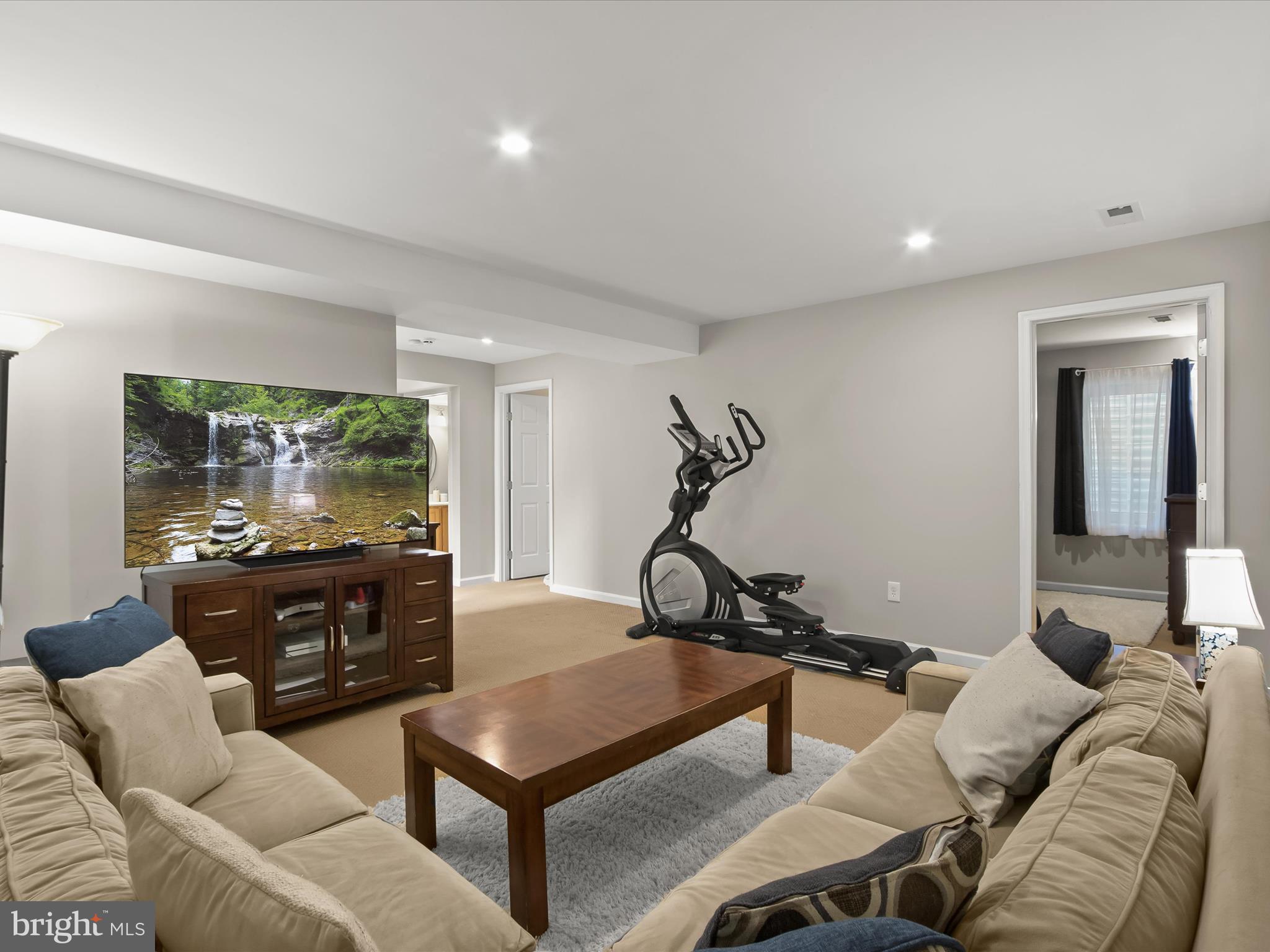 9808 Darcy Forest Drive Silver Spring, MD 20910 - Photo 51 of 82 a living room with furniture and a flat screen tv