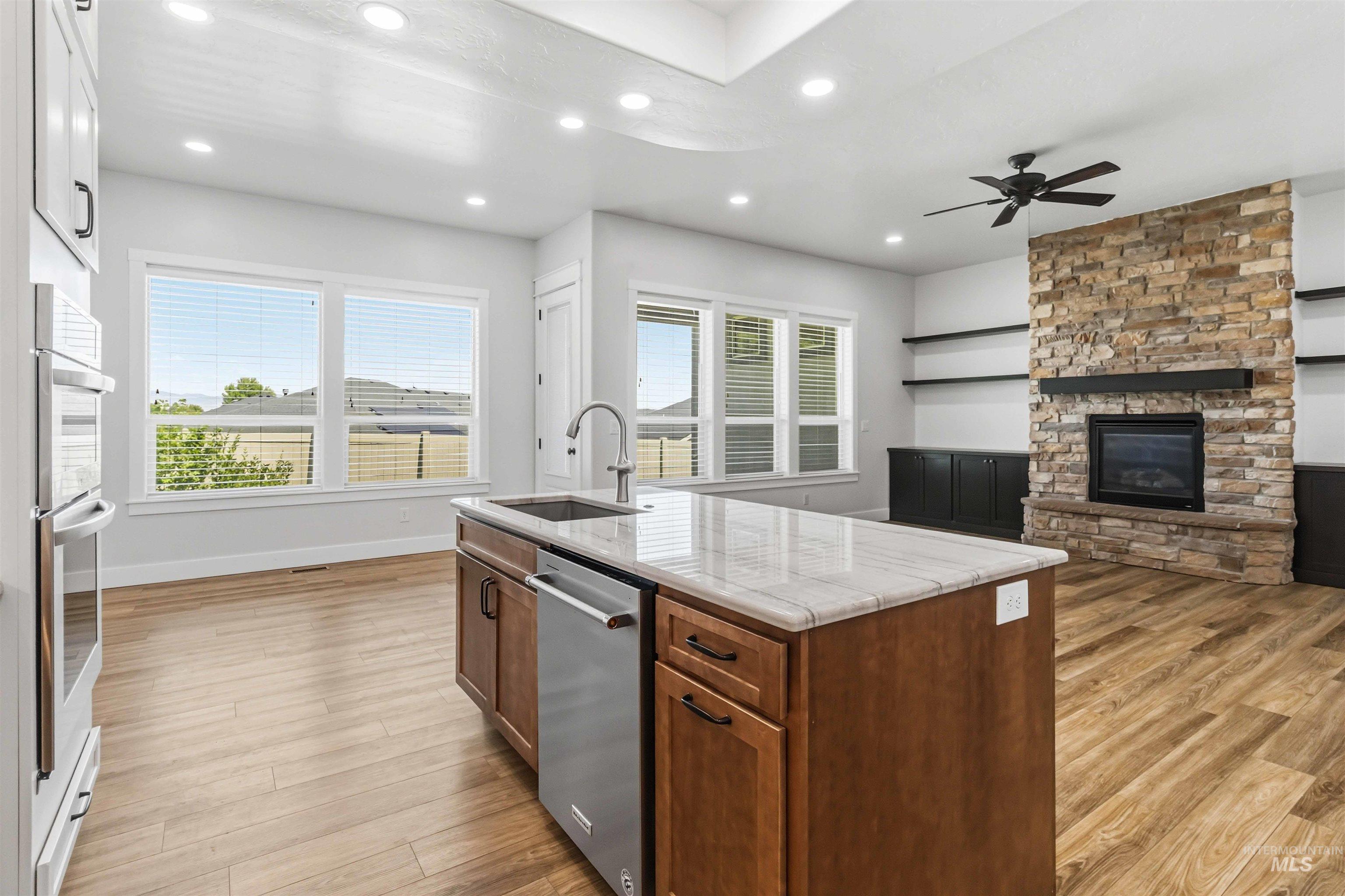 3218 North Cherry Laurel Way Star, ID 83669 - Photo 12 of 50 Modern kitchen featuring an expansive center island with an integrated sink and light-colored countertop