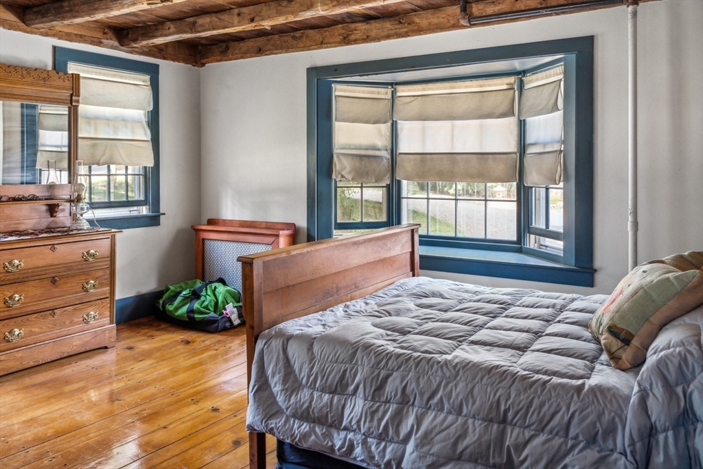 1251 County Road Bourne, MA 02534 - Photo 12 of 42 a bedroom with a bed and windows