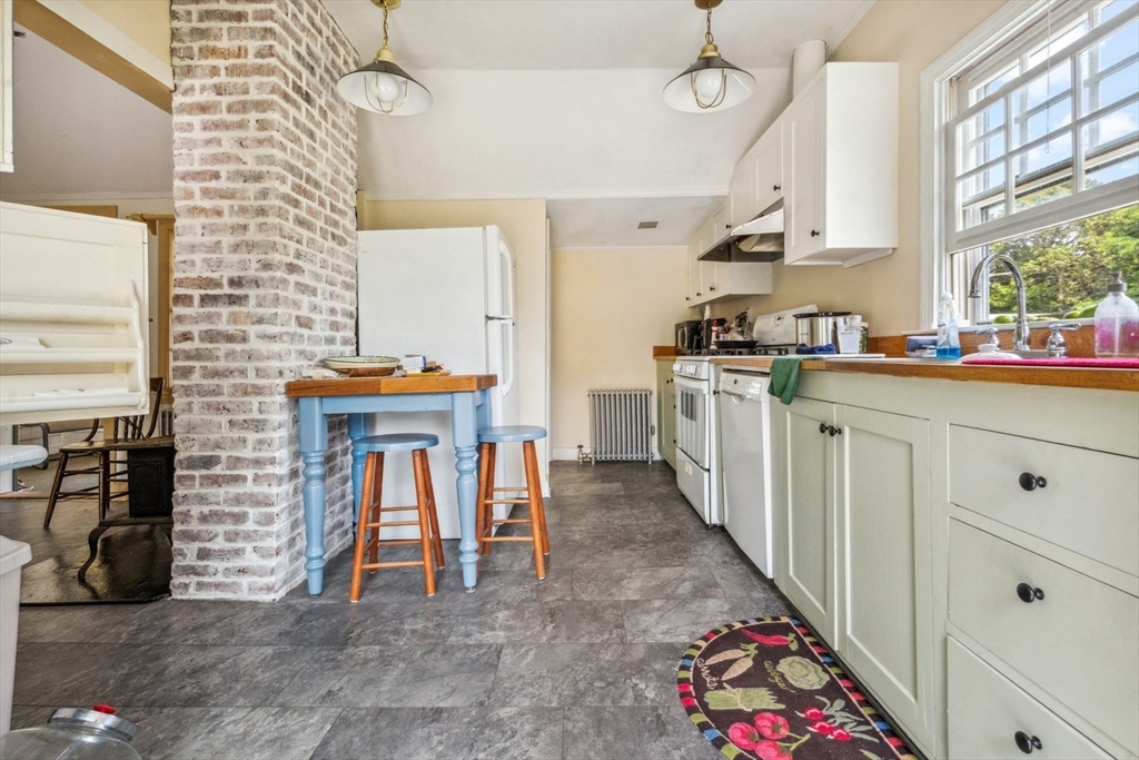 1251 County Road Bourne, MA 02534 - Photo 7 of 42 a kitchen with stainless steel appliances granite countertop a stove a sink and a refrigerator