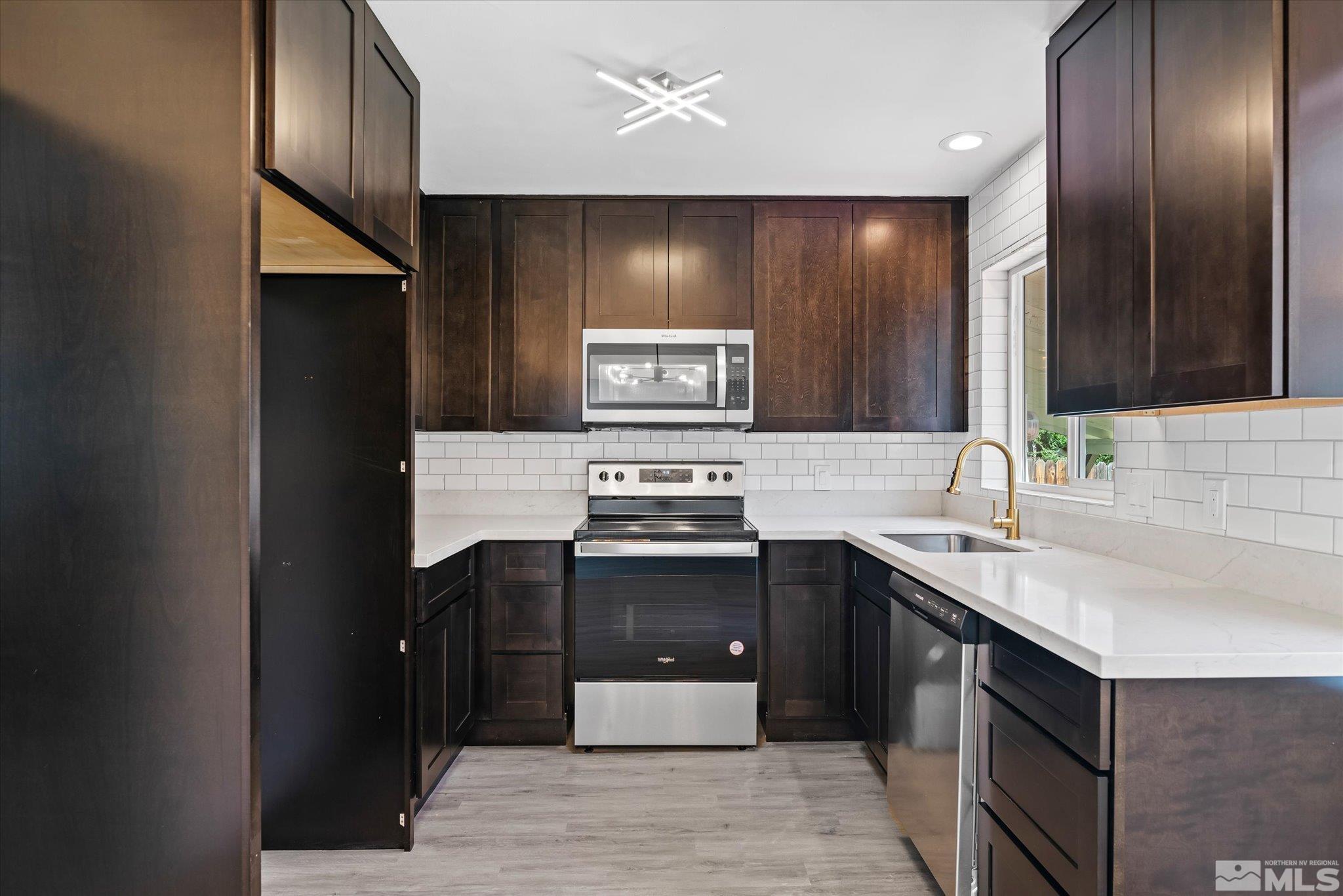 1760 Grandview Avenue Reno, NV 89503 - Photo 17 of 35 a kitchen with stainless steel appliances granite countertop a sink stove and cabinets