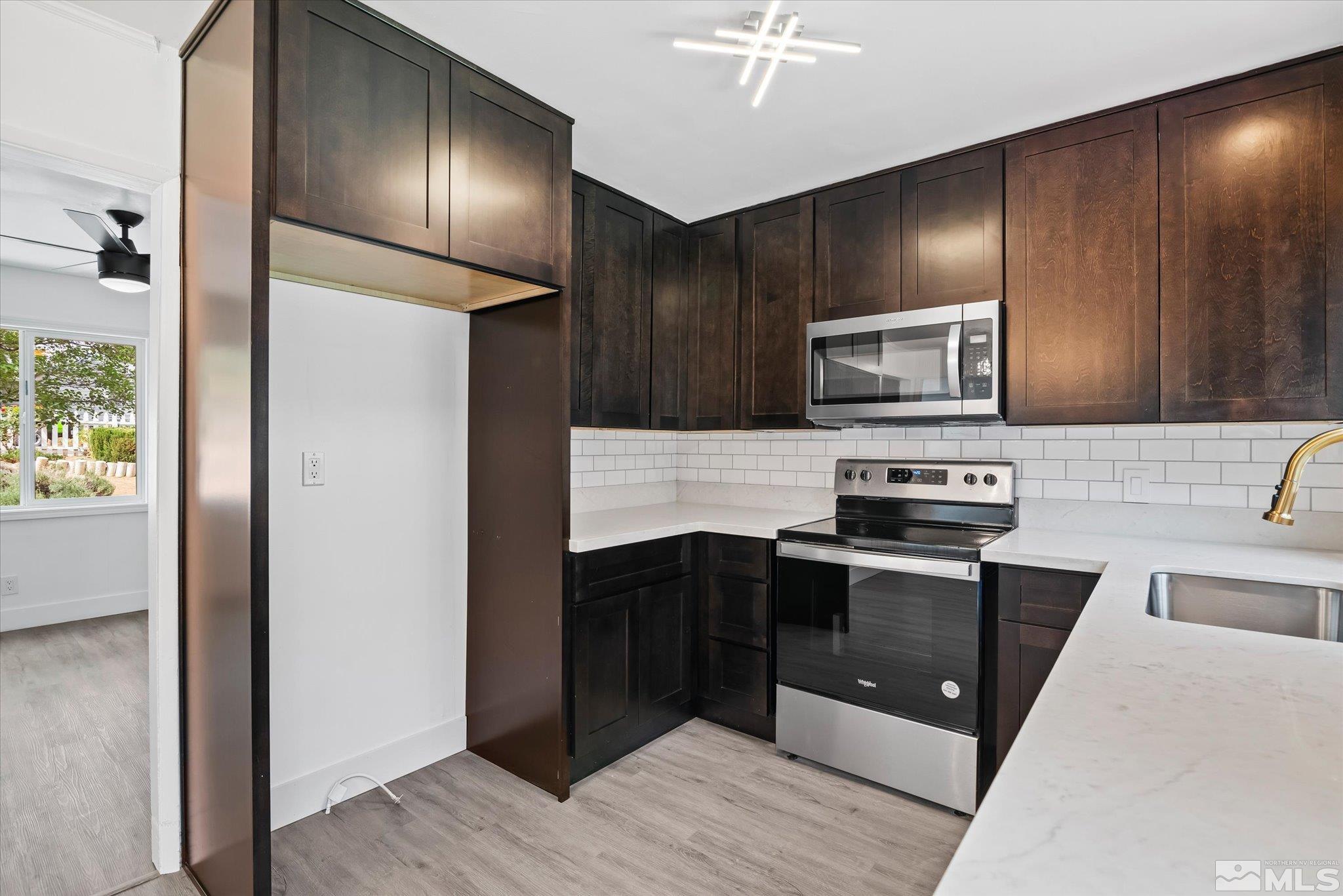 1760 Grandview Avenue Reno, NV 89503 - Photo 18 of 35 a kitchen with stainless steel appliances granite countertop a refrigerator and a sink
