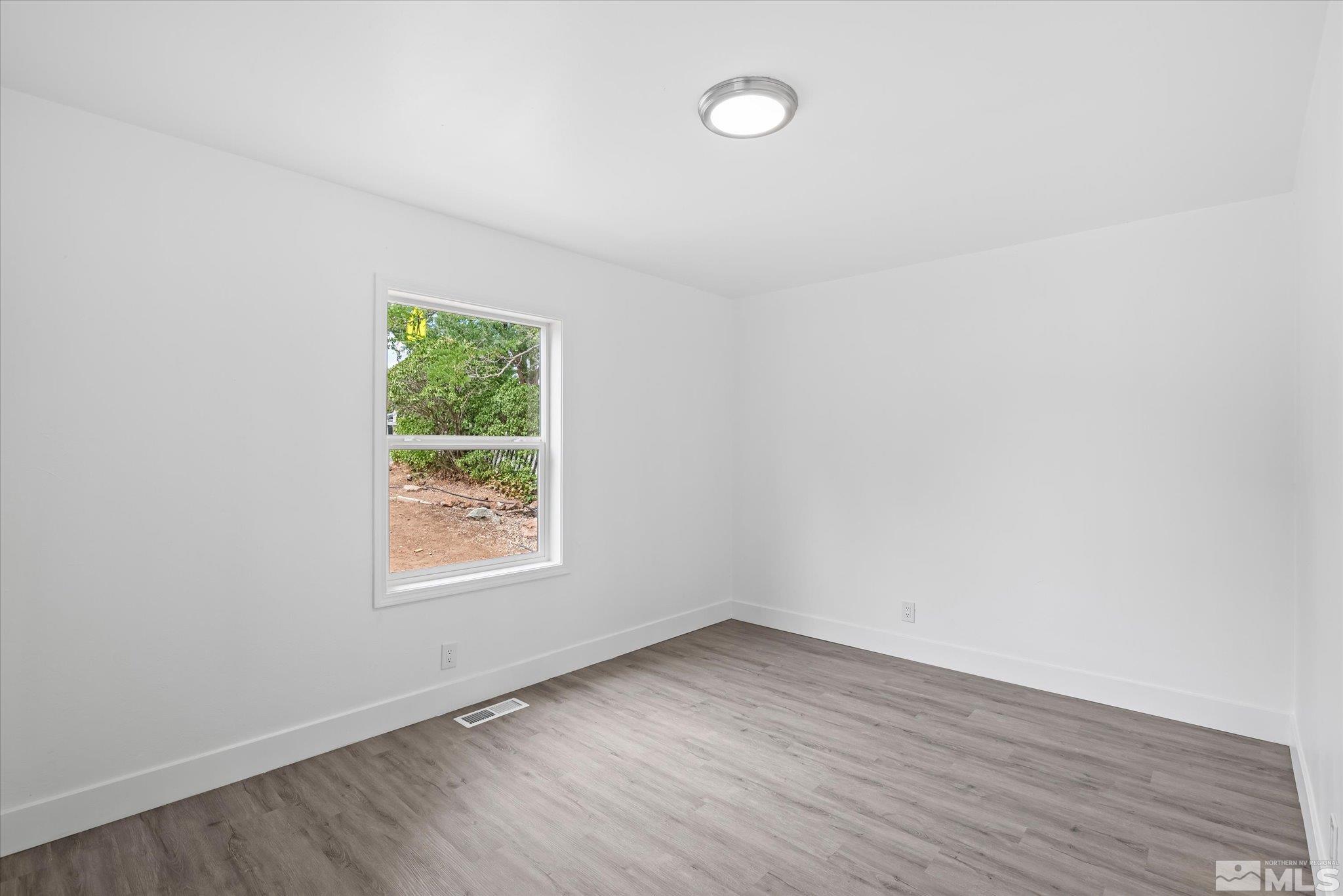 1760 Grandview Avenue Reno, NV 89503 - Photo 29 of 35 an empty room with wooden floor and windows