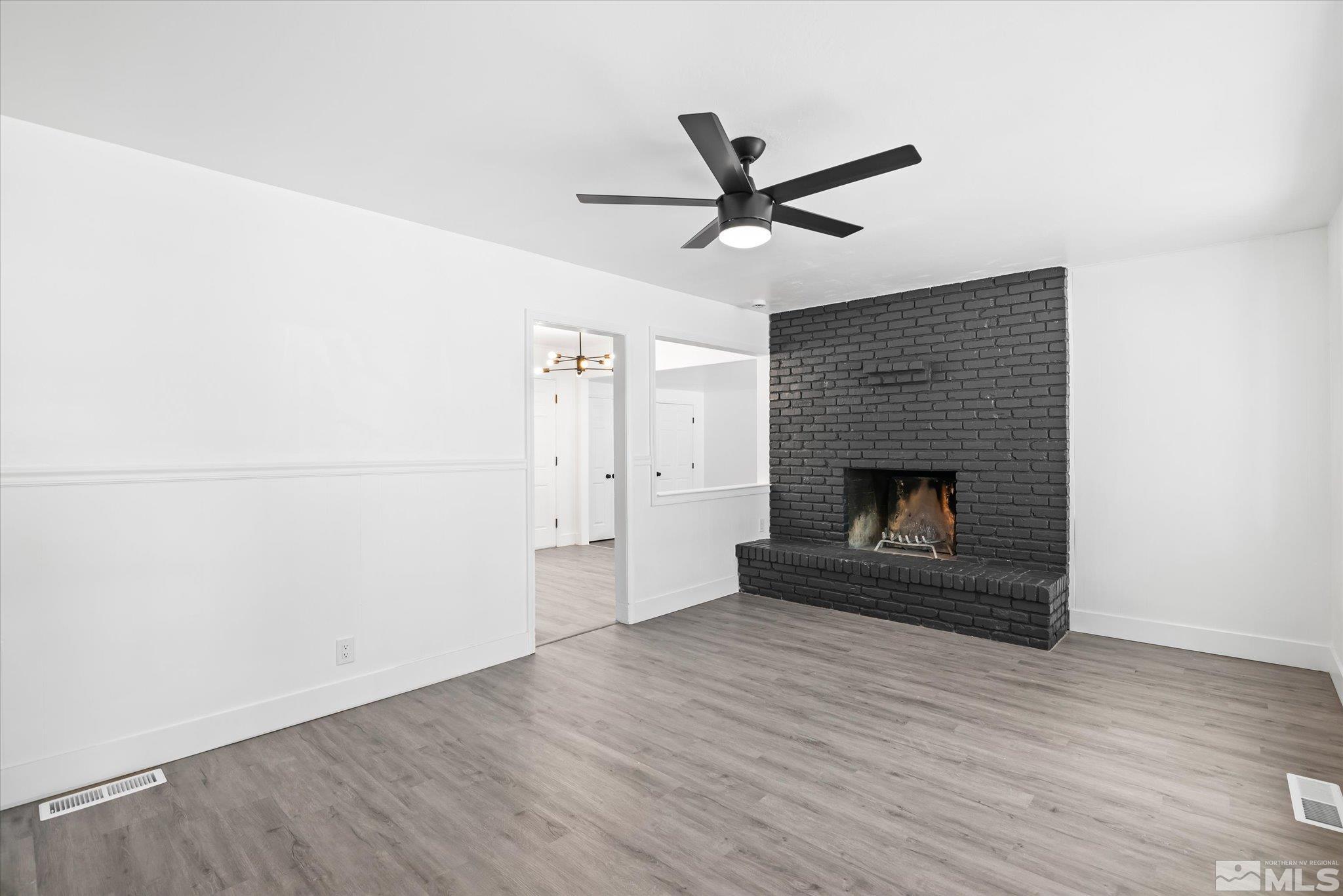 1760 Grandview Avenue Reno, NV 89503 - Photo 9 of 35 an empty room with wooden floor a fireplace