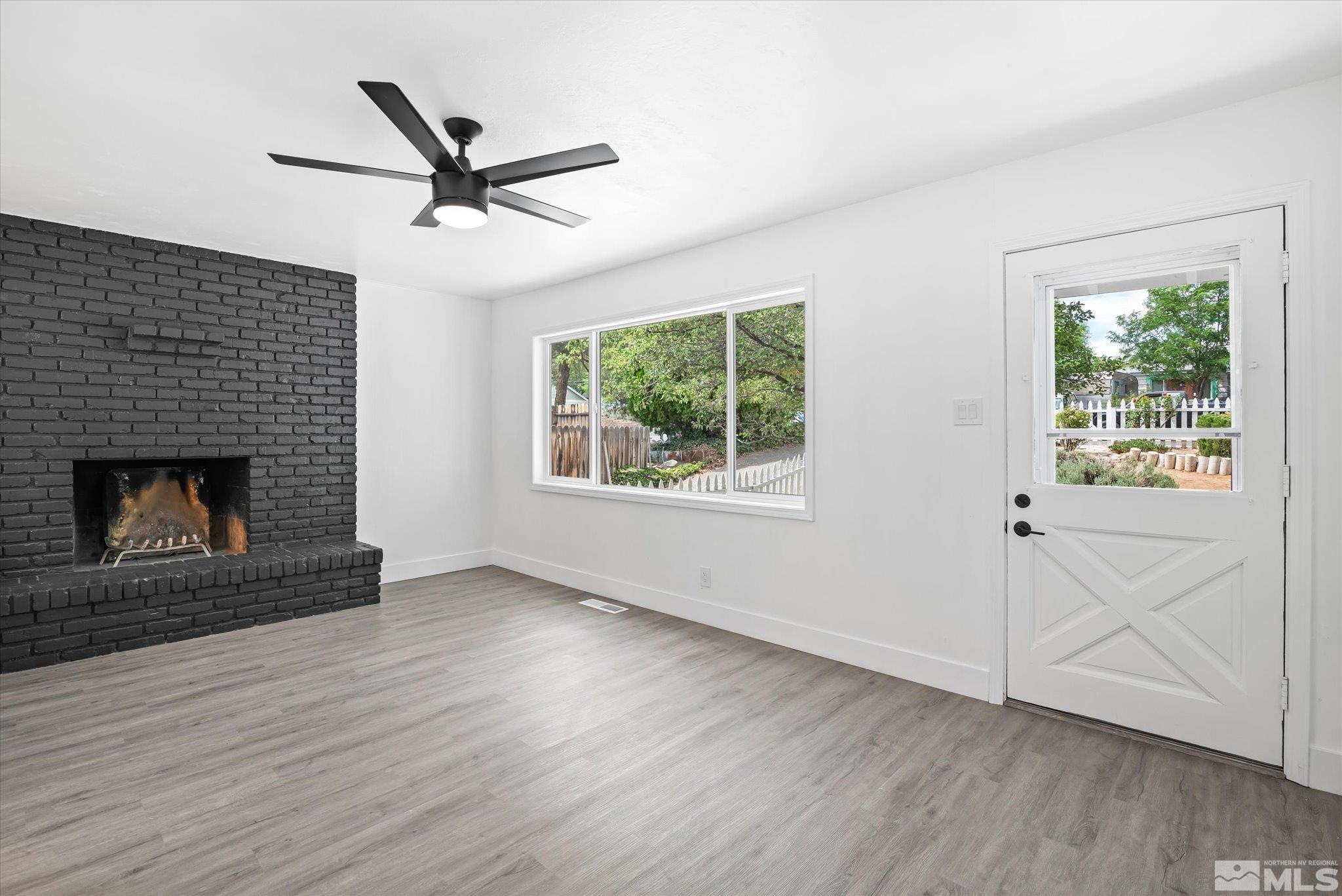 1760 Grandview Avenue Reno, NV 89503 - Photo 10 of 35 an empty room with wooden floor a ceiling fan and windows