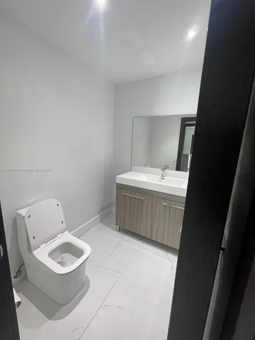 a bathroom with a shower sink and mirror