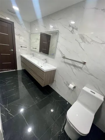 a kitchen with stainless steel appliances a refrigerator and a sink