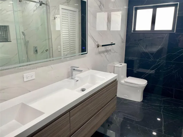 a kitchen with stainless steel appliances a large counter top a sink and cabinets