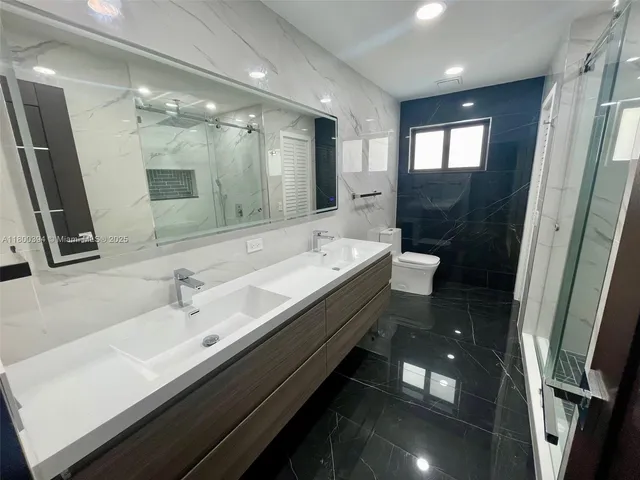 a kitchen with stainless steel appliances a refrigerator and a sink