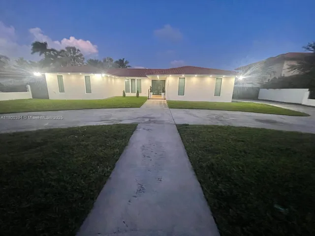 a view of a house with a yard patio and sitting area