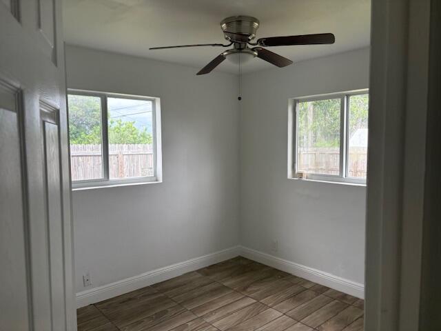 958 West 3rd Street Riviera Beach, FL 33404 - Photo 7 of 10 a view of empty room with wooden floor and fan