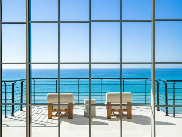a kitchen with stainless steel appliances kitchen island granite countertop a table and chairs in it