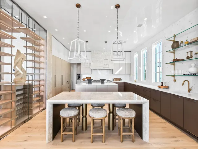 a dining room with furniture and a floor to ceiling window