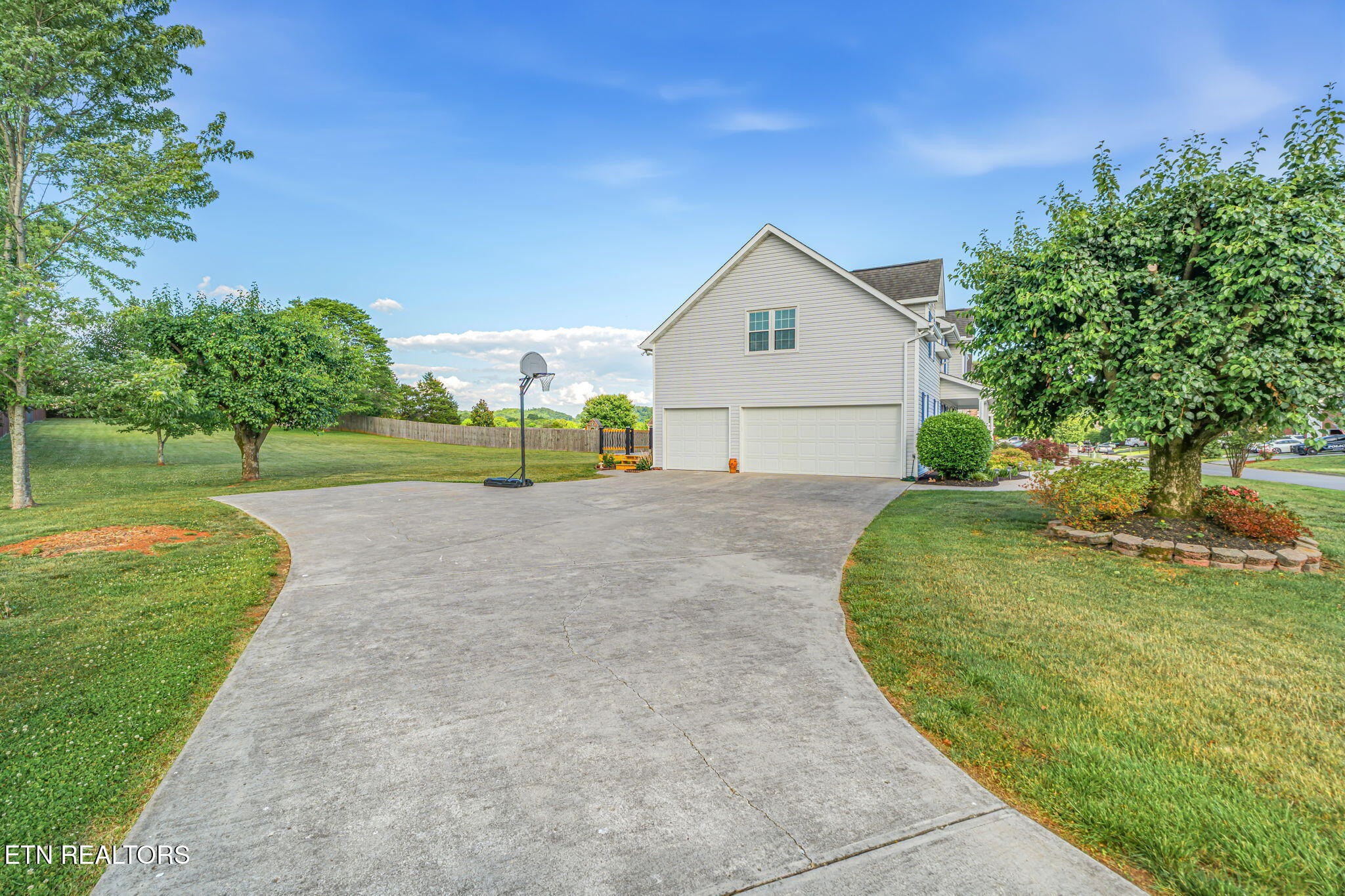 7030 Westerly Winds Road Knoxville, TN 37931 - Photo 2 of 40 a view of a house with a yard and garage