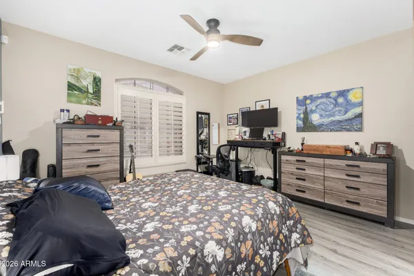 a bed room with a bed and a flat screen tv