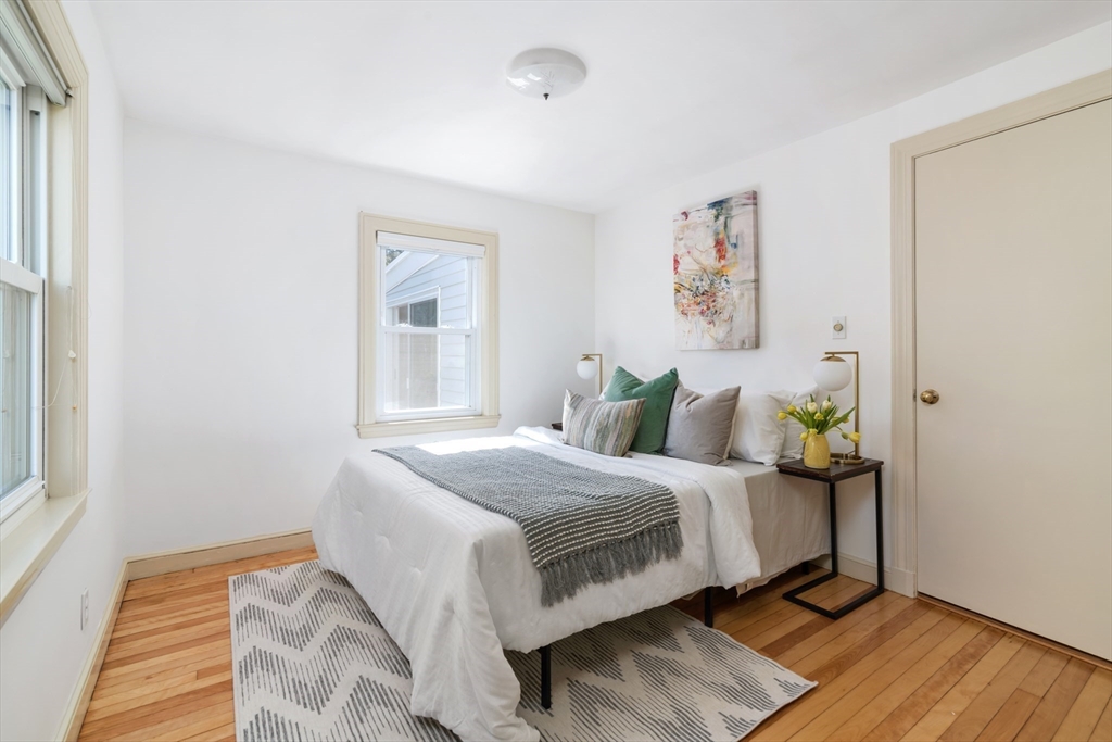 18 Kenilworth Road Arlington, MA 02476 - Photo 11 of 26 a bedroom with a bed and wooden floor