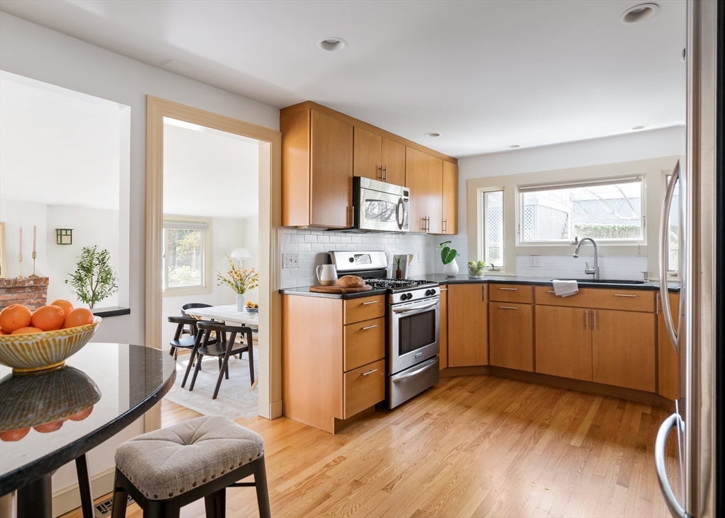 18 Kenilworth Road Arlington, MA 02476 - Photo 7 of 26 a kitchen with stainless steel appliances granite countertop a stove a sink and a refrigerator