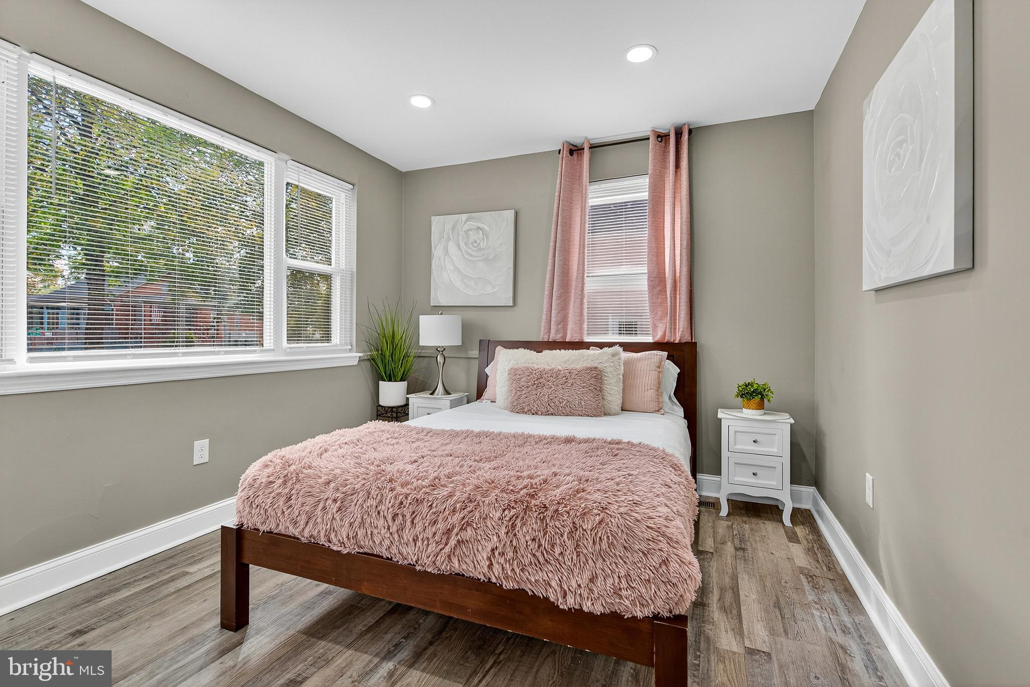 3310 Glen Avenue Baltimore, MD 21215 - Photo 11 of 33 a bedroom with a bed and wooden floor