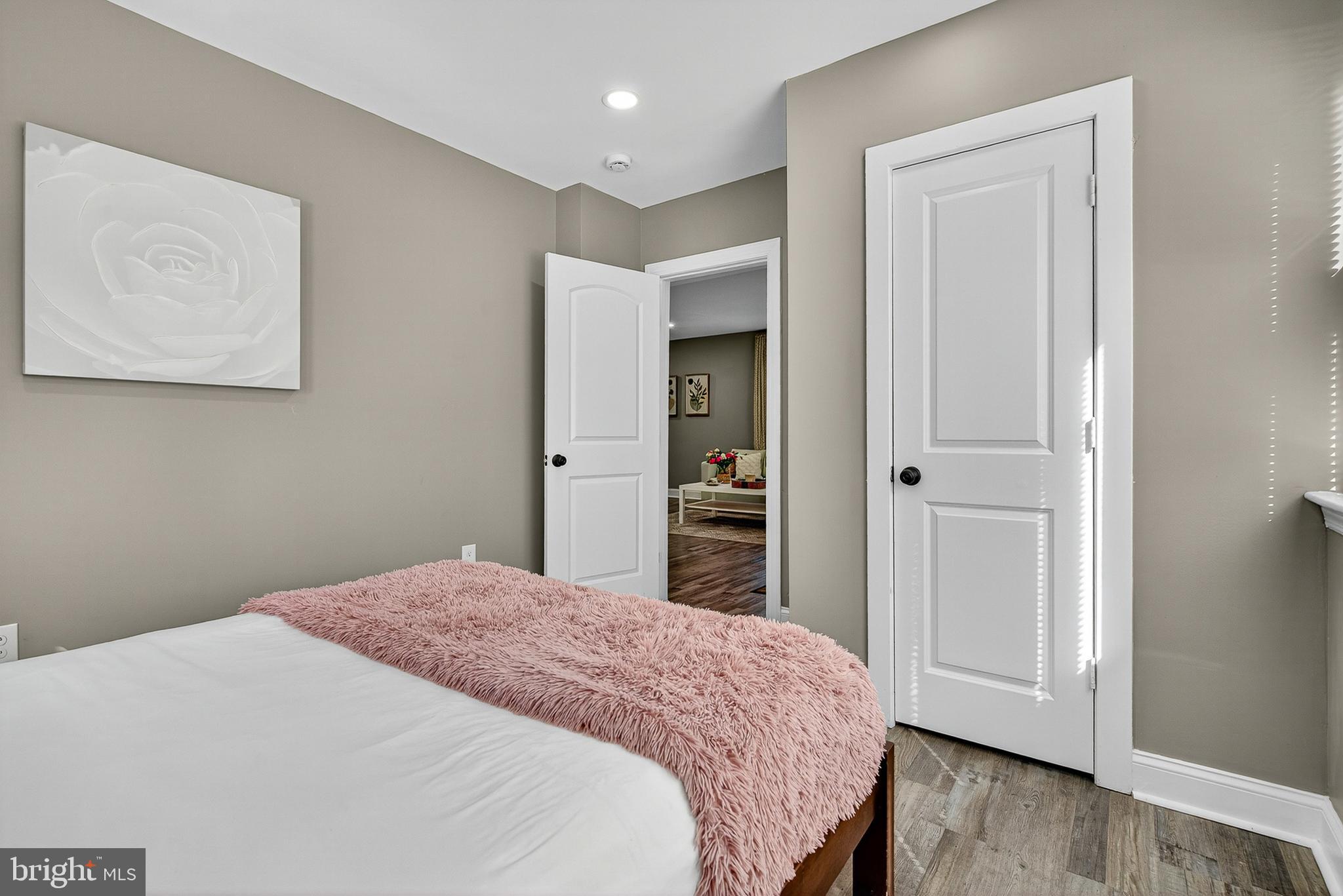 3310 Glen Avenue Baltimore, MD 21215 - Photo 12 of 33 a bedroom with a bed and wooden floor