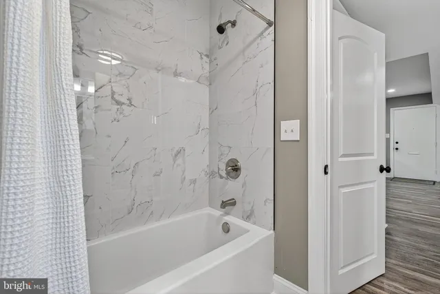 a bathroom with a bathtub and a shower