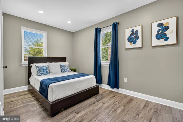 a bedroom with a bed and painting on the wall