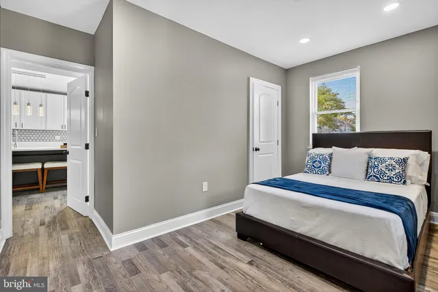a bedroom with a bed and a view of kitchen