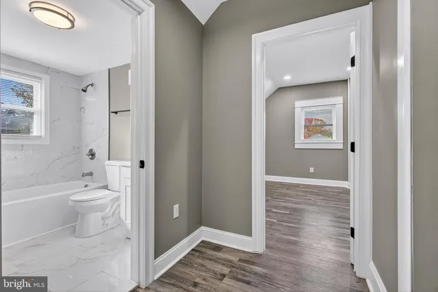 a bathroom with a granite countertop toilet sink and shower
